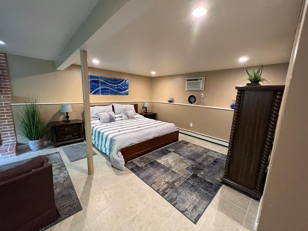 142 Clay Pond Road Bourne, MA 02532 - Photo 21 of 42 a bedroom with a large bed and a couch