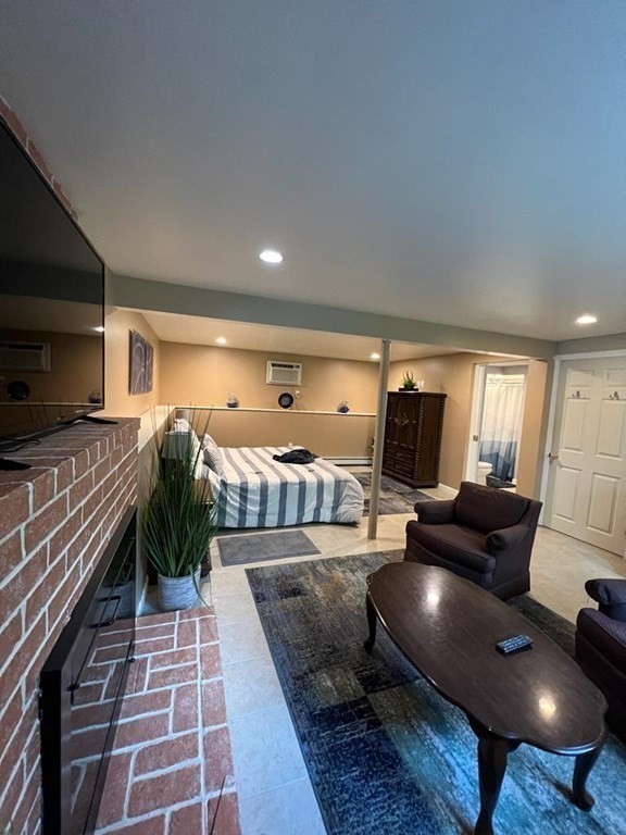142 Clay Pond Road Bourne, MA 02532 - Photo 22 of 42 a living room with furniture and a flat screen tv