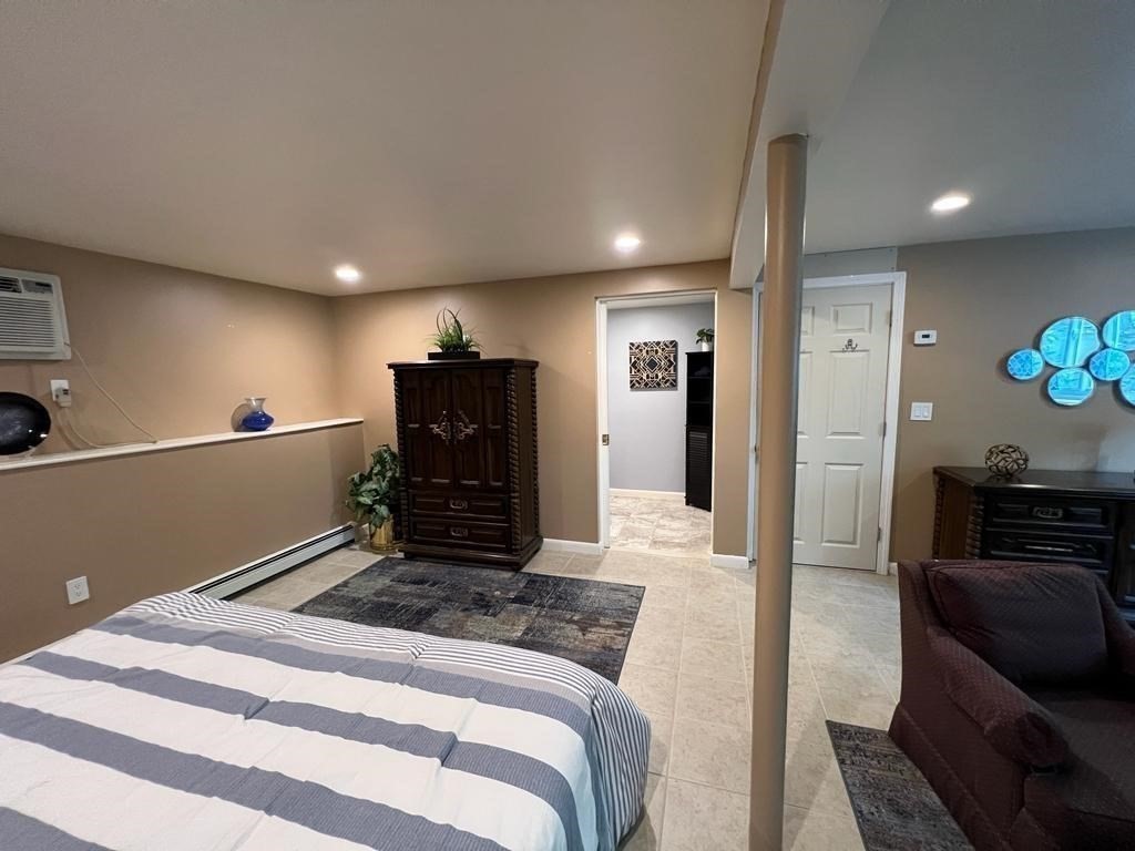 142 Clay Pond Road Bourne, MA 02532 - Photo 24 of 42 a spacious bedroom with a bed and furniture
