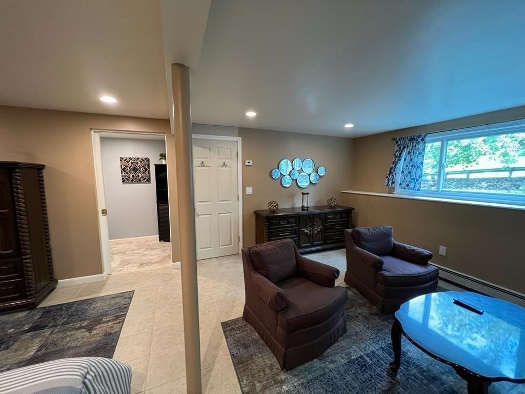 142 Clay Pond Road Bourne, MA 02532 - Photo 25 of 42 a living room with furniture and a flat screen tv