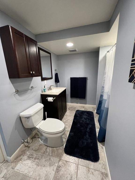 142 Clay Pond Road Bourne, MA 02532 - Photo 26 of 42 a bathroom with a toilet sink and mirror