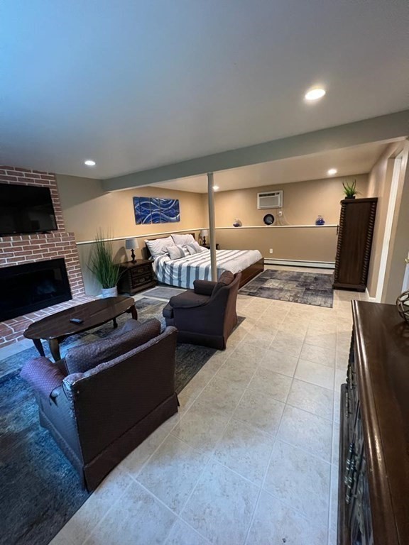 142 Clay Pond Road Bourne, MA 02532 - Photo 28 of 42 a living room with furniture and a flat screen tv