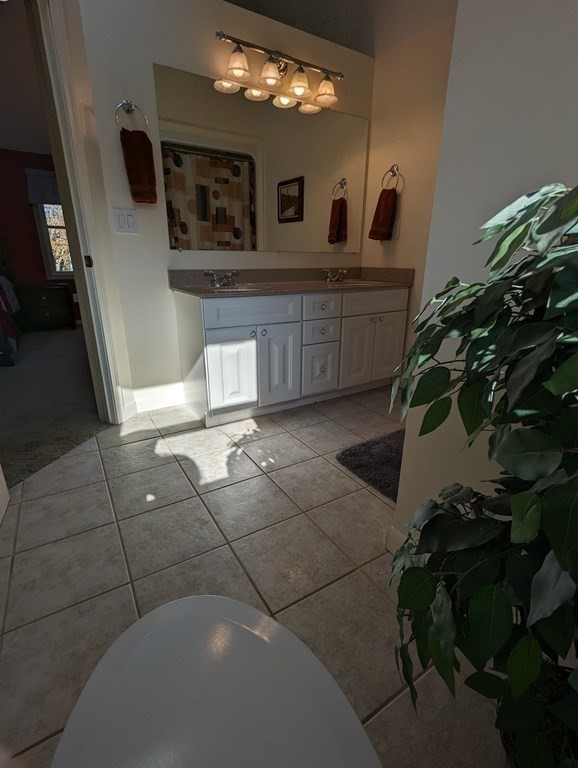 142 Clay Pond Road Bourne, MA 02532 - Photo 29 of 42 a spacious bathroom with a sink and a mirror