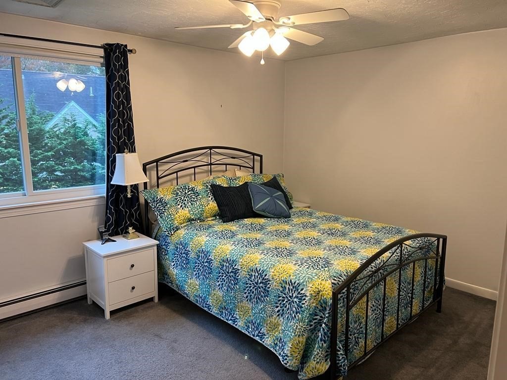 142 Clay Pond Road Bourne, MA 02532 - Photo 30 of 42 a bedroom with a bed and a window