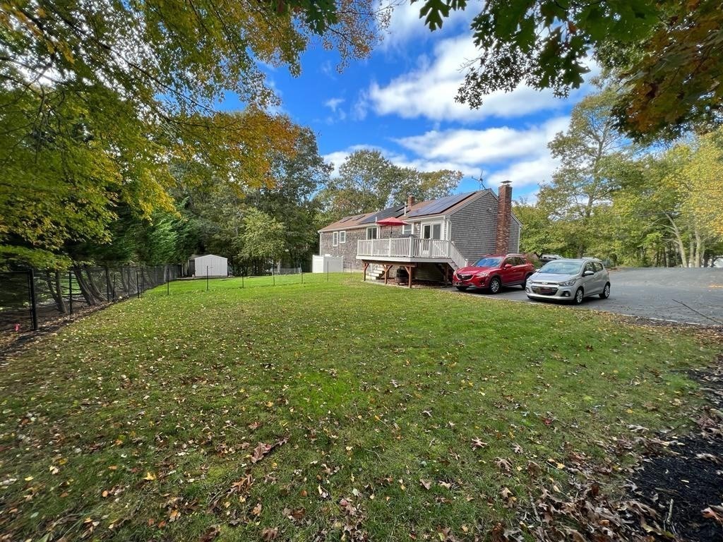 142 Clay Pond Road Bourne, MA 02532 - Photo 3 of 42 a view of a house with a big yard