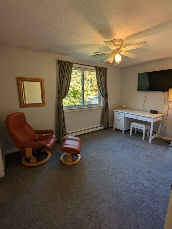 142 Clay Pond Road Bourne, MA 02532 - Photo 32 of 42 a living room with furniture a window and a flat screen tv