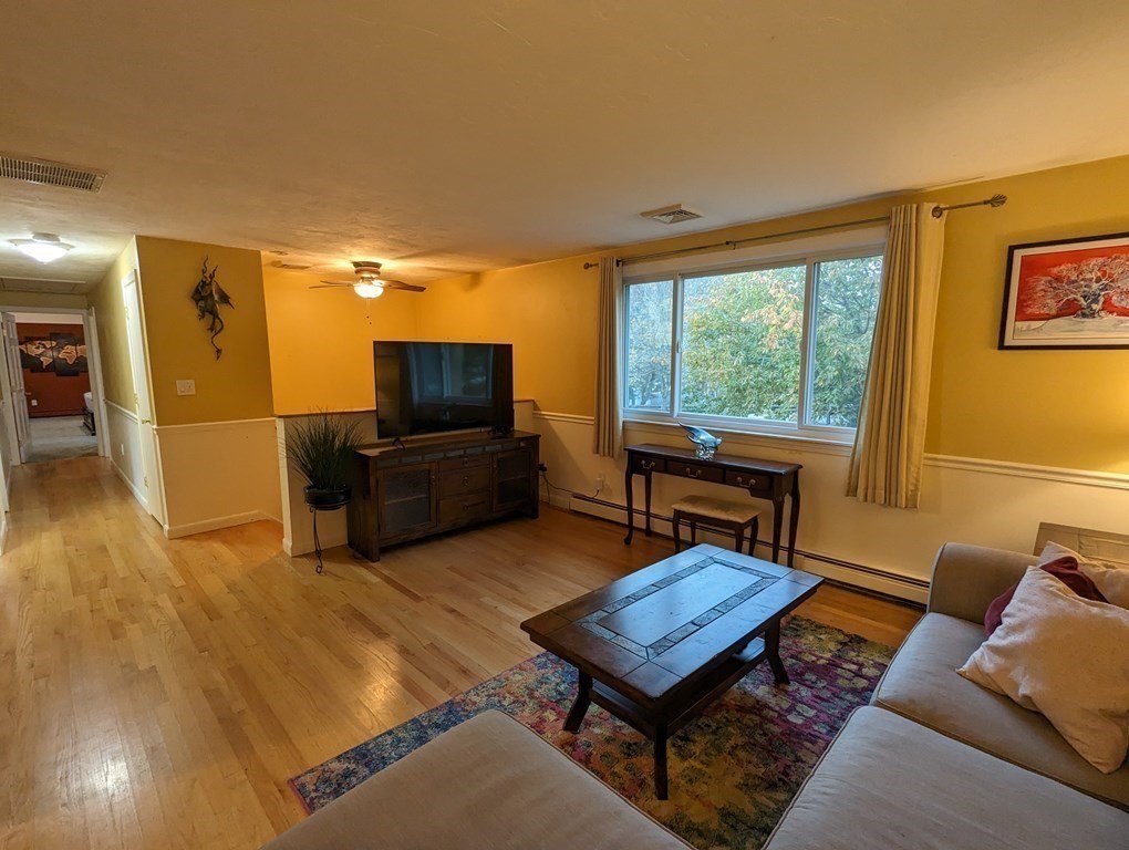 142 Clay Pond Road Bourne, MA 02532 - Photo 35 of 42 a living room with furniture and a flat screen tv