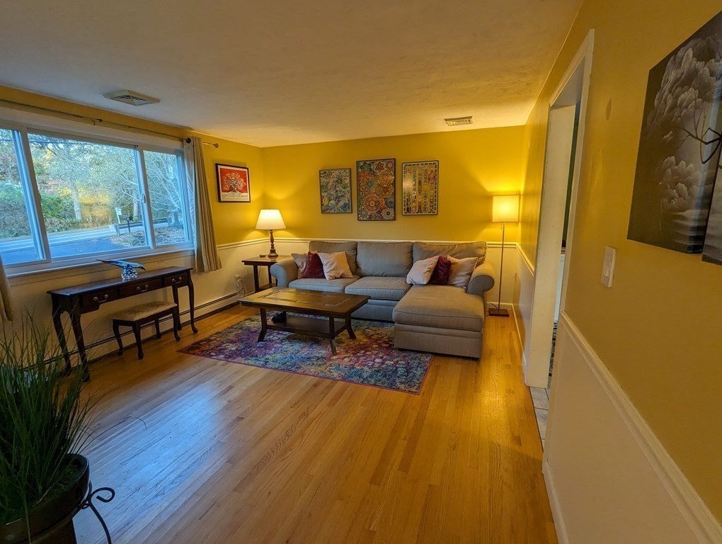 142 Clay Pond Road Bourne, MA 02532 - Photo 36 of 42 a living room with furniture and a wooden floor