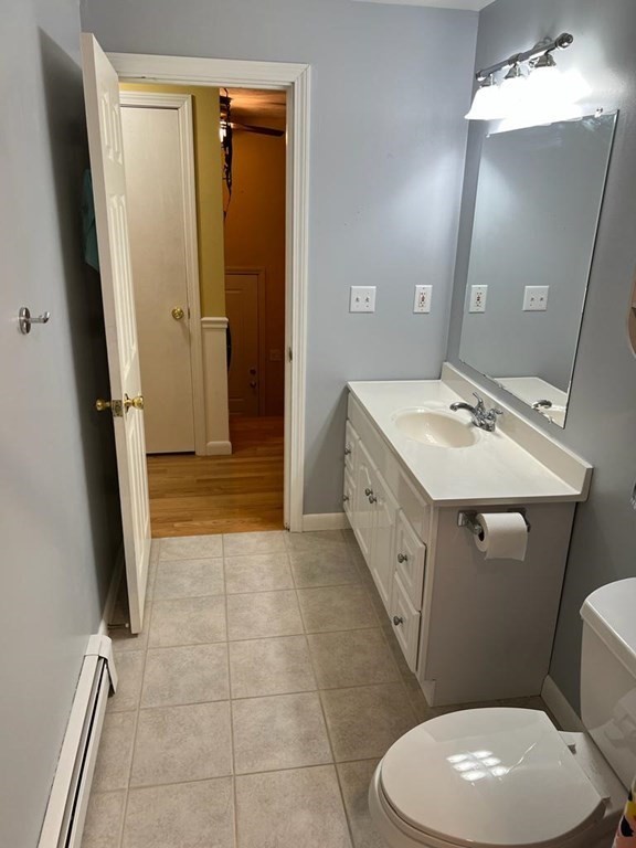 142 Clay Pond Road Bourne, MA 02532 - Photo 38 of 42 a spacious bathroom with a toilet a sink a mirror and vanity