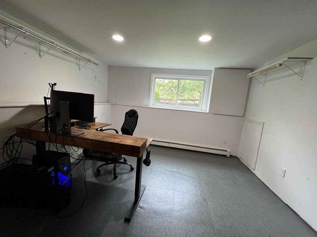 142 Clay Pond Road Bourne, MA 02532 - Photo 39 of 42 a view of a workspace with furniture and a window