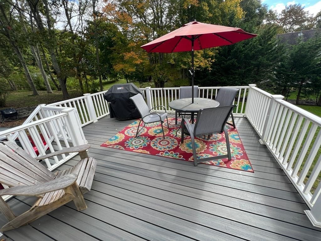 142 Clay Pond Road Bourne, MA 02532 - Photo 7 of 42 a view of balcony with wooden floor and outdoor seating