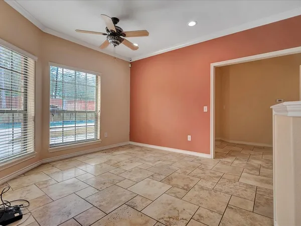 a view of a livingroom with a ceiling fan and window