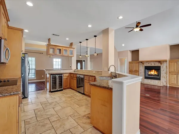 a kitchen with stainless steel appliances kitchen island granite countertop a sink and cabinets