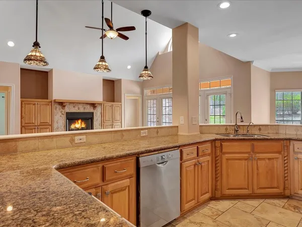 a open kitchen with stainless steel appliances granite countertop a stove a sink and a microwave