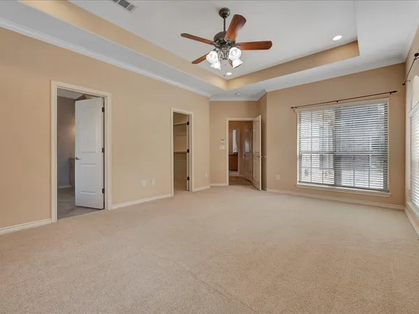 a view of an empty room with a ceiling fan