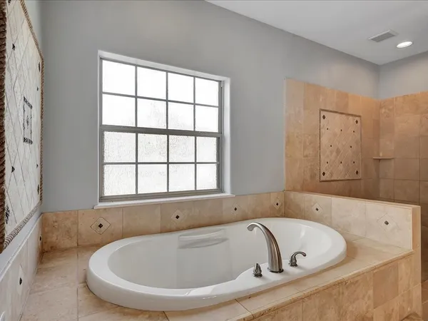 a bath tub sitting in a bathroom next to a window