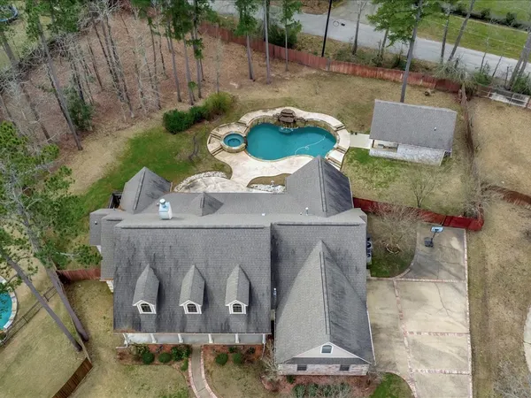 an aerial view of a house with garden space and a patio