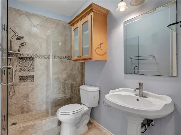 a bathroom with a sink toilet and shower