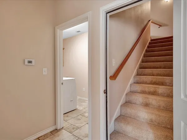 a view of a hallway with wooden floor and entryway