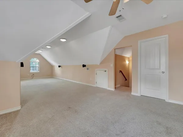 an empty room with window and wooden floor