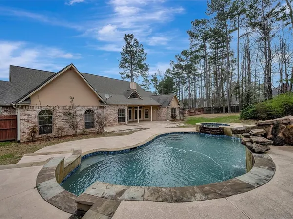 a view of a house with pool and sitting area