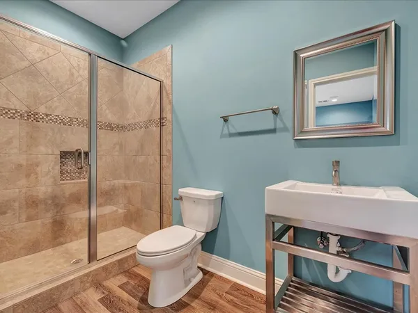 a bathroom with a toilet a sink and a shower