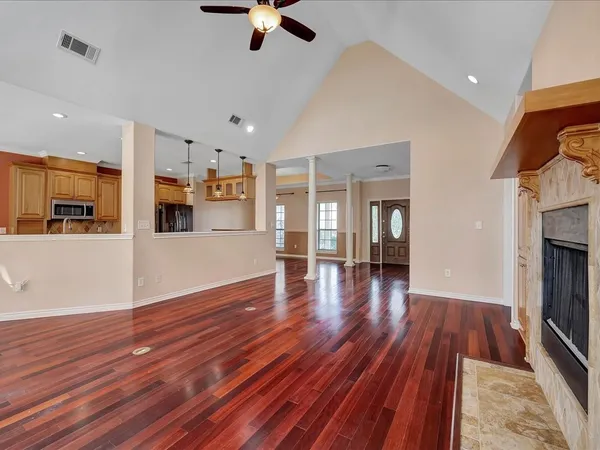 a view of a kitchen with furniture and wooden floor