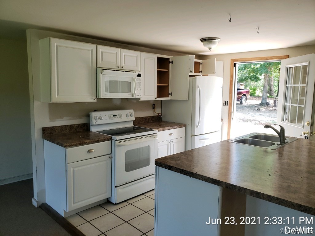 12613 Doyle Road Dewitt, VA 23840 - Photo 6 of 22 a kitchen with stainless steel appliances granite countertop a sink a stove counter space and cabinets