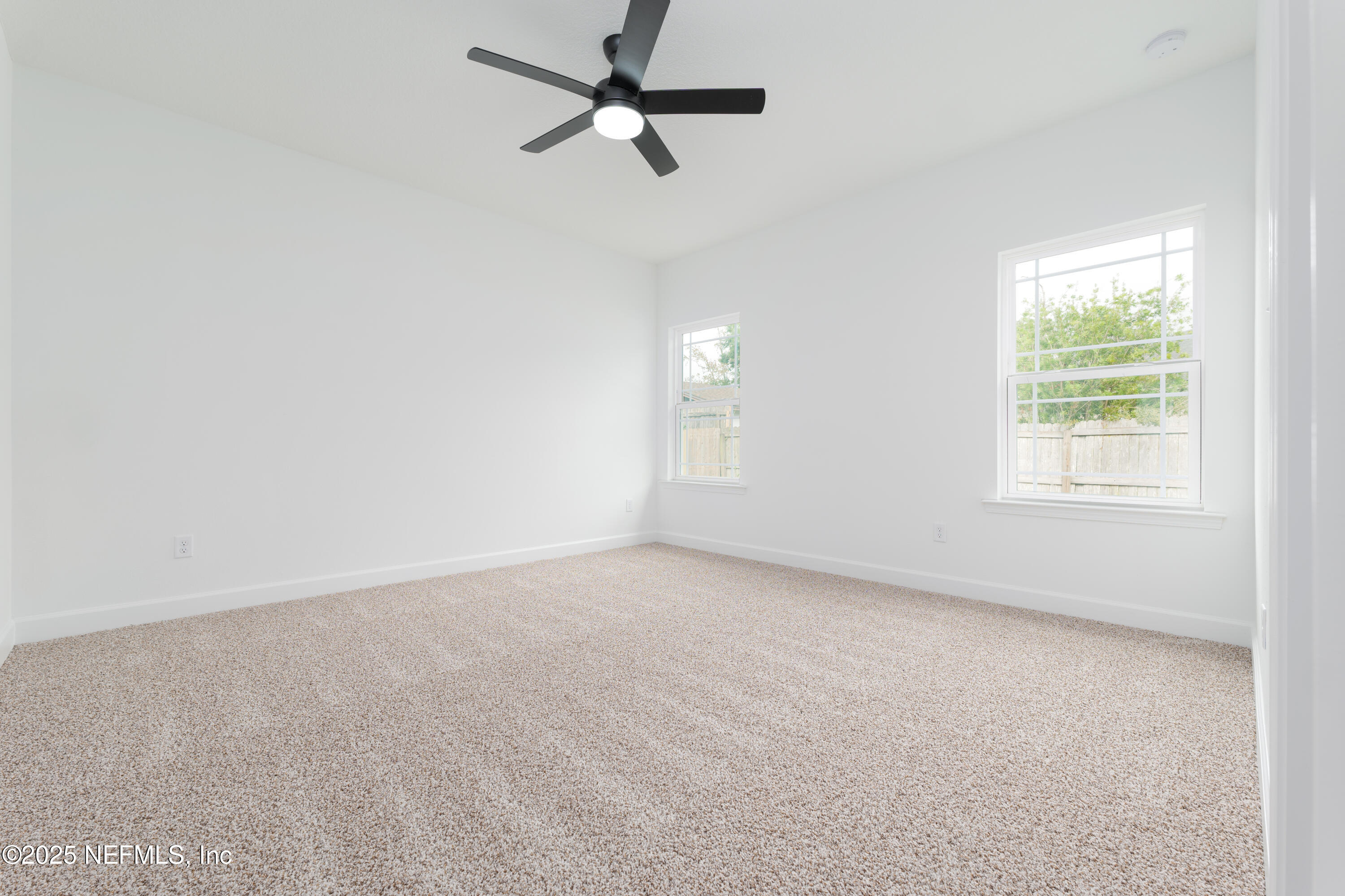 7596 Silver Sands Road Keystone Heights, FL 32656 - Photo 11 of 26 an empty room with a window and a fan