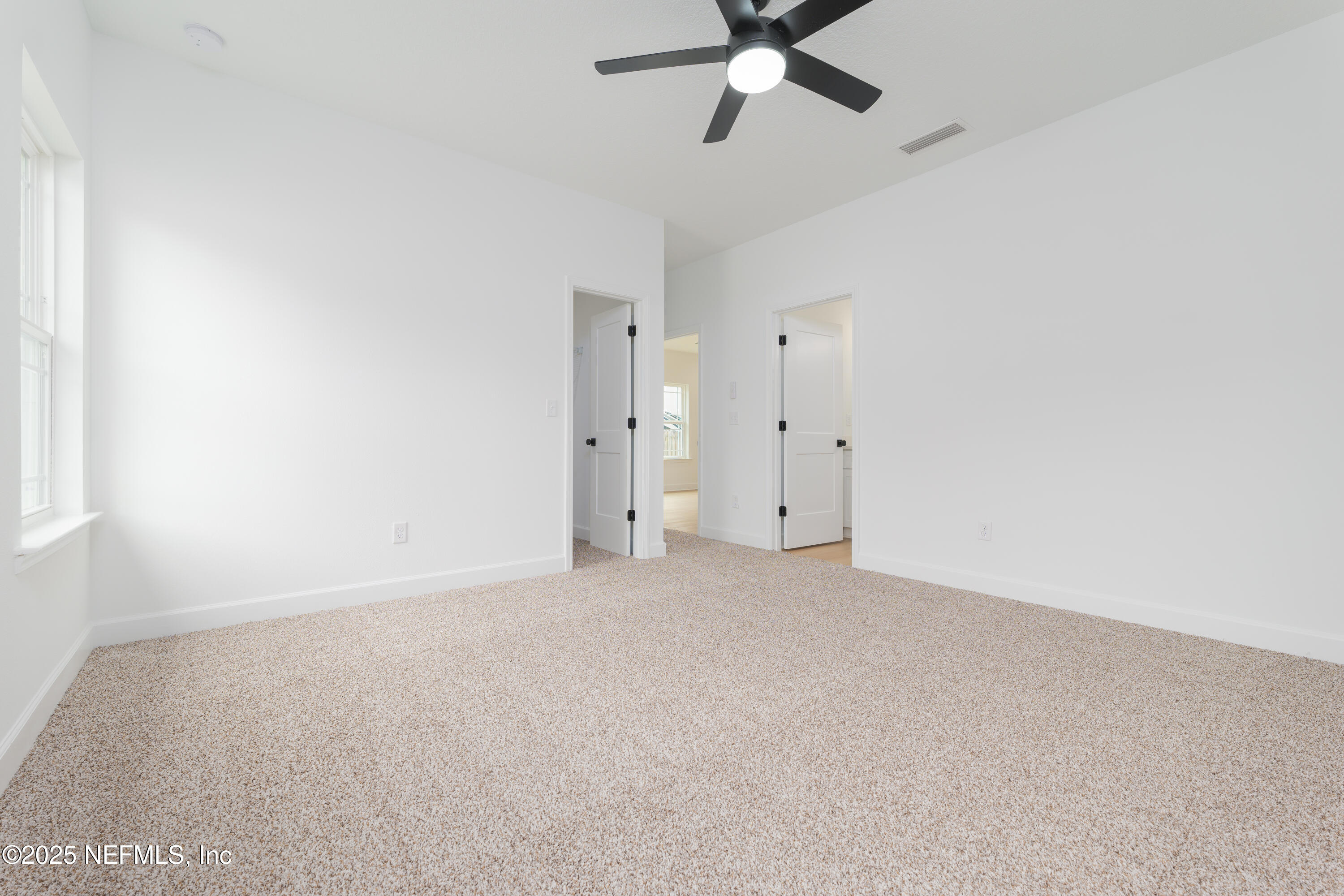7596 Silver Sands Road Keystone Heights, FL 32656 - Photo 12 of 26 an empty room with a window and a fan