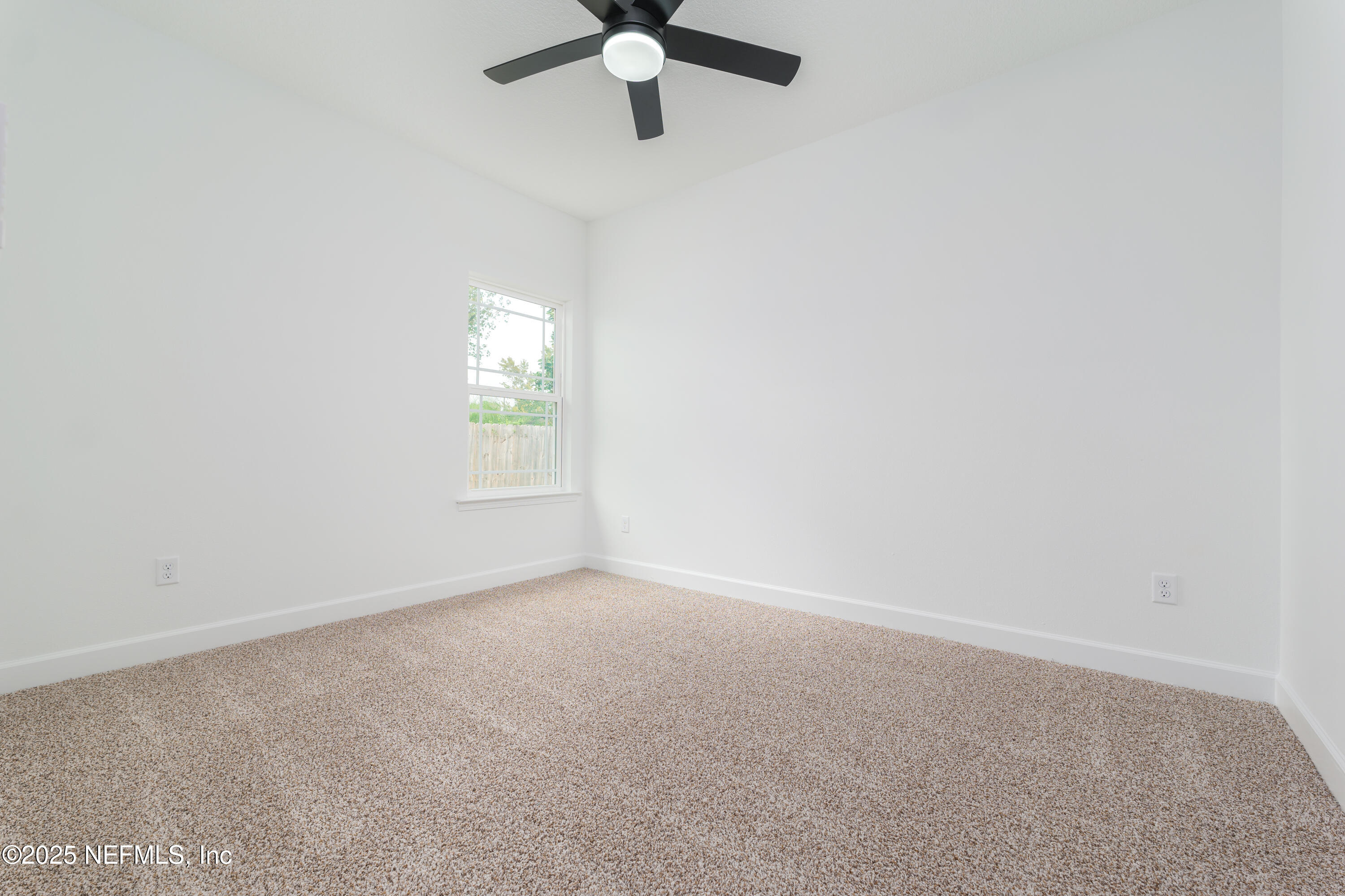 7596 Silver Sands Road Keystone Heights, FL 32656 - Photo 19 of 26 an empty room with a window and a fan