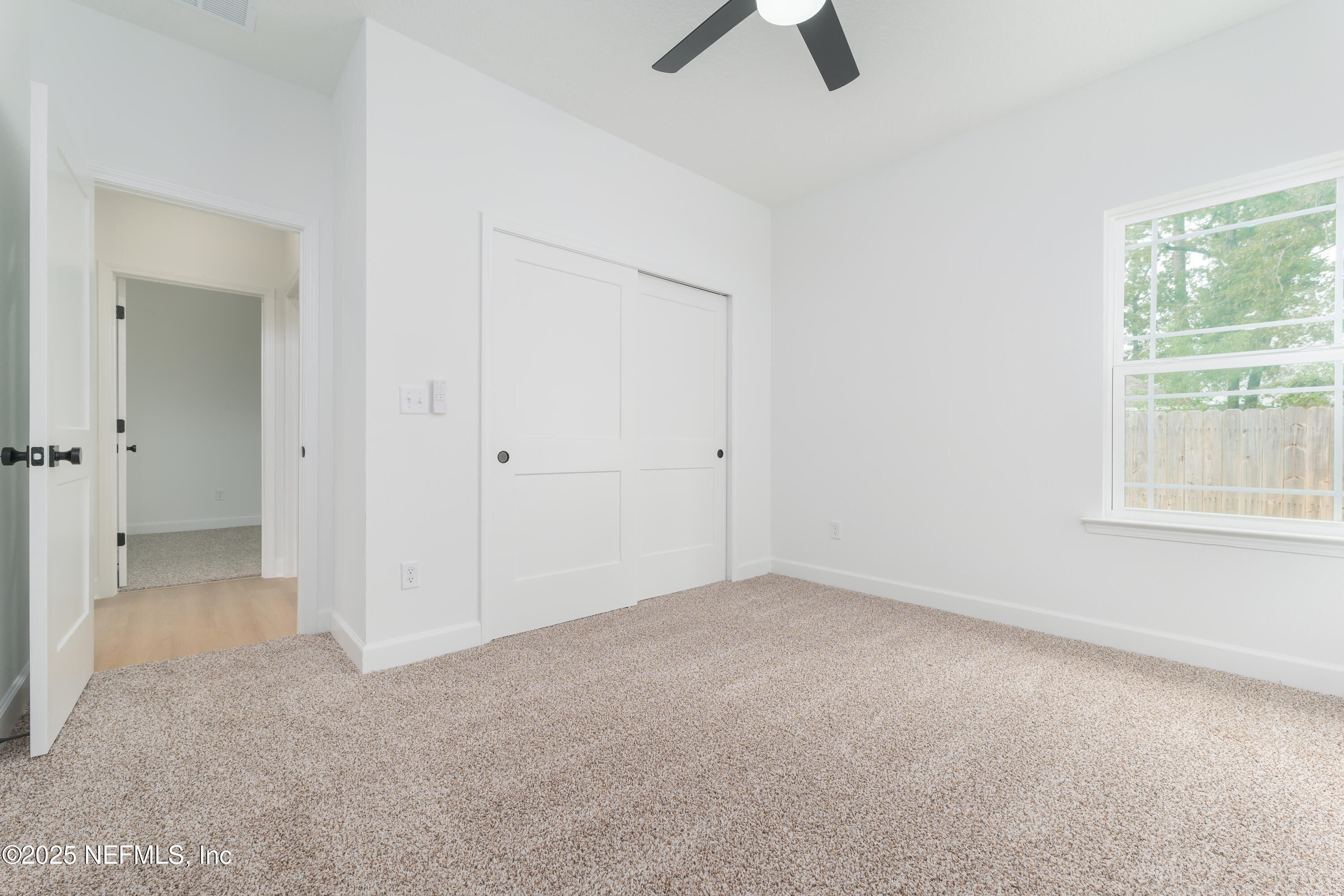 7596 Silver Sands Road Keystone Heights, FL 32656 - Photo 20 of 26 an empty room with ceiling fan and window