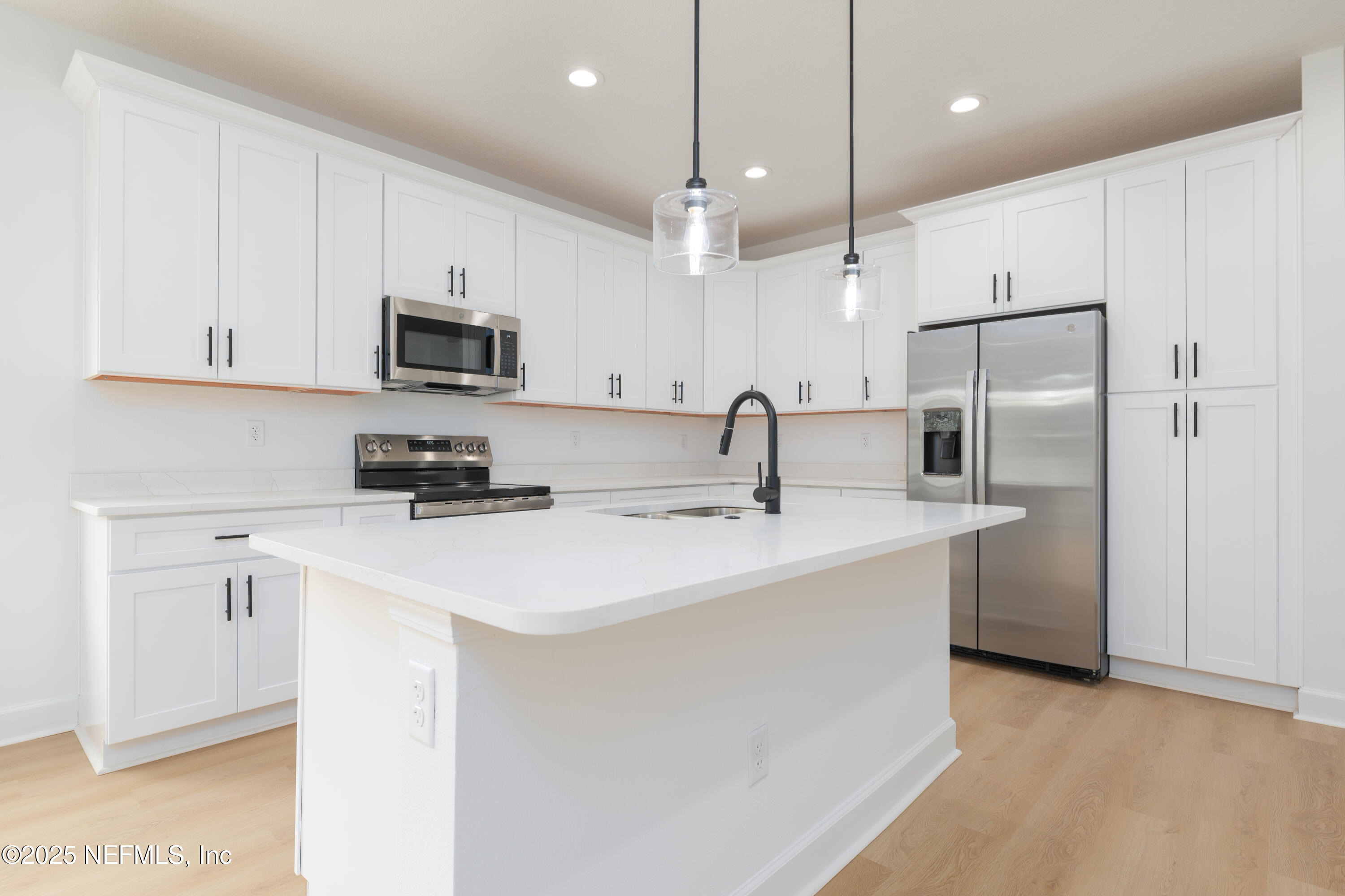 7596 Silver Sands Road Keystone Heights, FL 32656 - Photo 5 of 26 a kitchen with stainless steel appliances a refrigerator sink and microwave