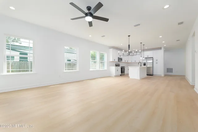 a view of a kitchen with a sink and a window