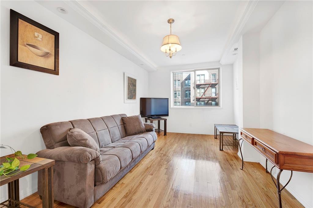 202 Quentin Road, Unit 2B Brooklyn, NY 11223 - Photo 2 of 16 a living room with furniture and a wooden floor