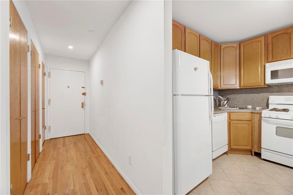 202 Quentin Road, Unit 2B Brooklyn, NY 11223 - Photo 5 of 16 a view of a kitchen with cabinets and stainless steel appliances