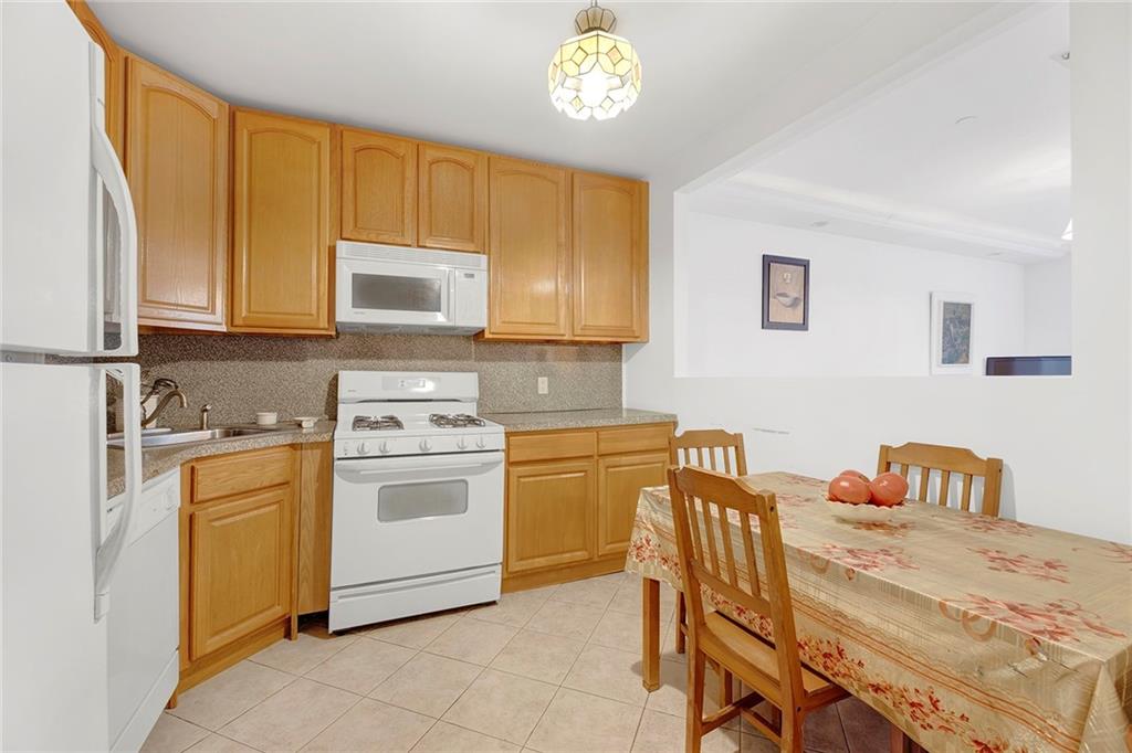 202 Quentin Road, Unit 2B Brooklyn, NY 11223 - Photo 6 of 16 a kitchen with a stove a sink and a refrigerator