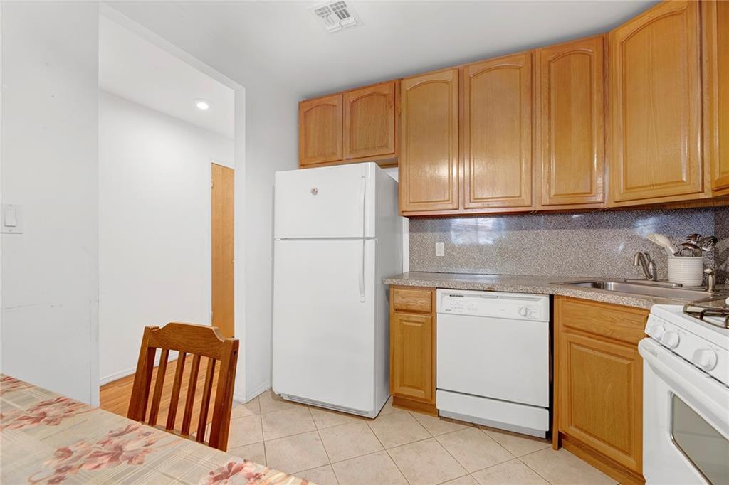 202 Quentin Road, Unit 2B Brooklyn, NY 11223 - Photo 7 of 16 a kitchen with a refrigerator and cabinets