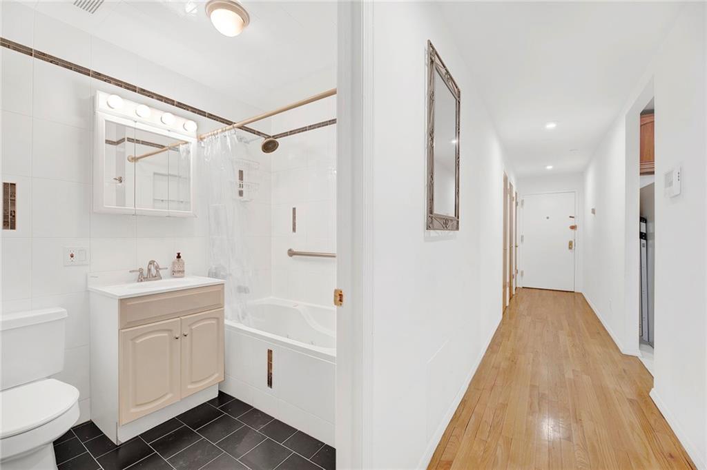 202 Quentin Road, Unit 2B Brooklyn, NY 11223 - Photo 9 of 16 a bathroom with a sink a toilet and a shower