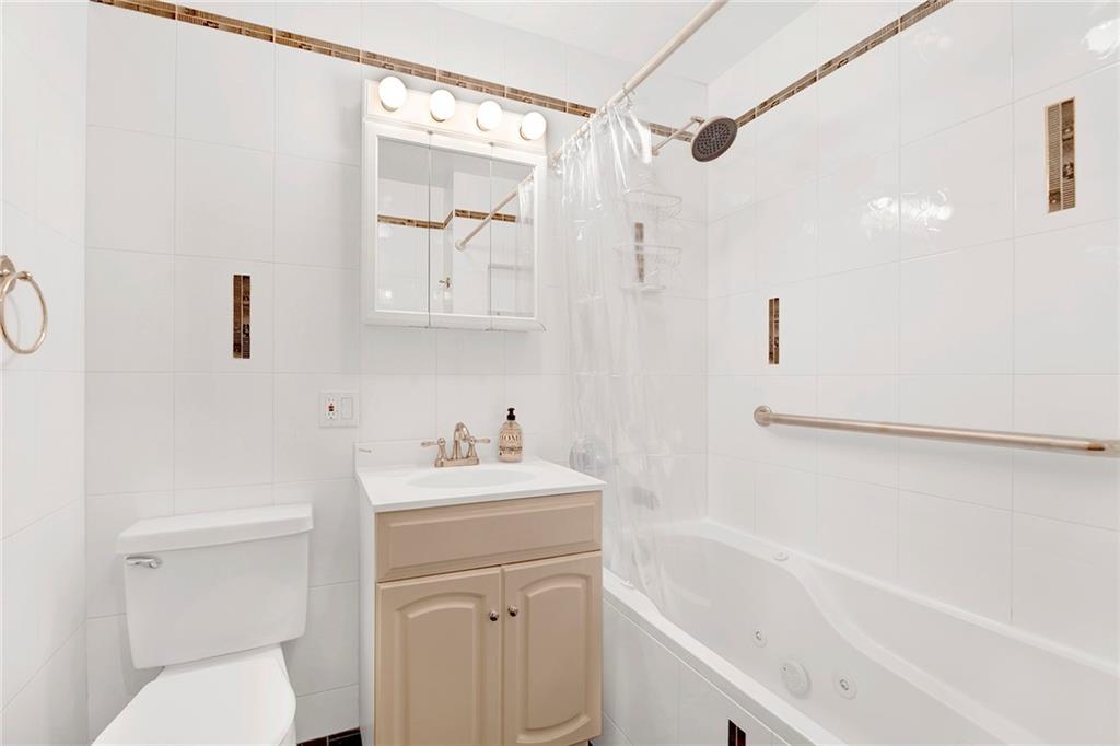 202 Quentin Road, Unit 2B Brooklyn, NY 11223 - Photo 10 of 16 a bathroom with a sink a toilet and shower