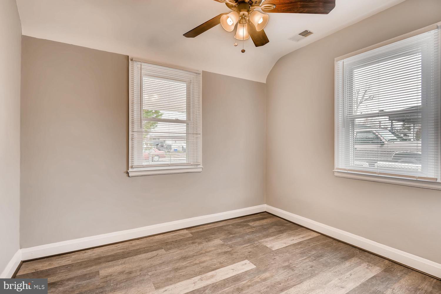 3501 Louth Road Baltimore, MD 21222 - Photo 7 of 27 a view of an empty room with a window and wooden floor