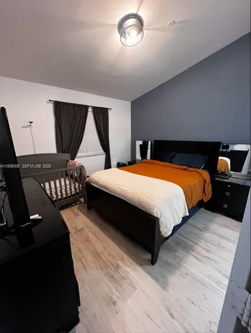 a bedroom with bed and window