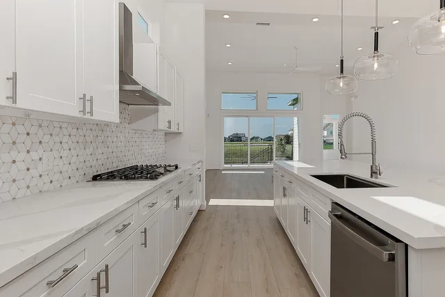 a kitchen with a sink stove and cabinets
