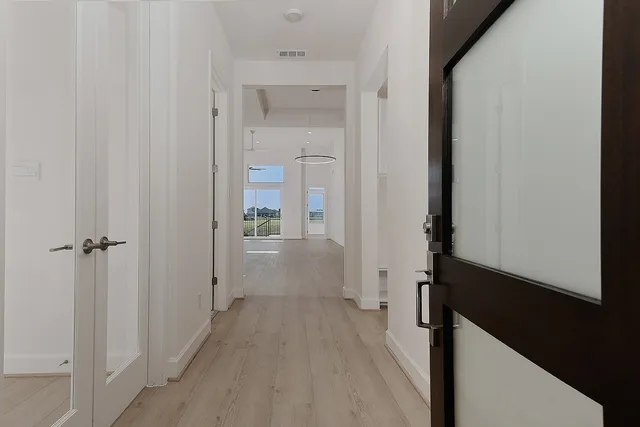 a view of a hallway with a wooden door