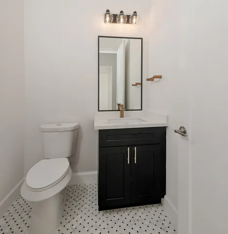 a bathroom with a toilet a sink and mirror