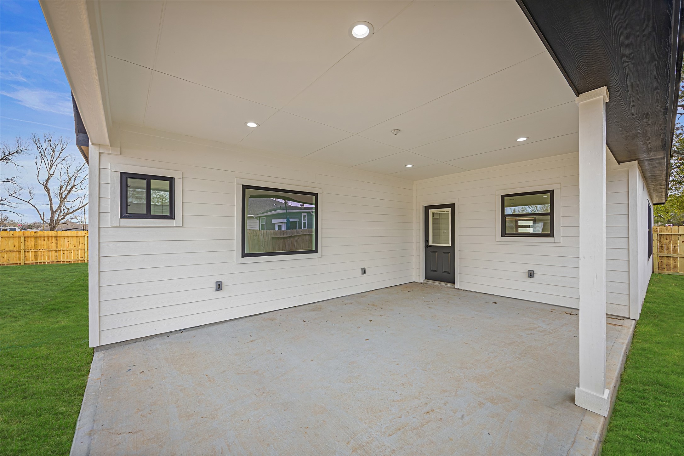 1807 Waco Street Dayton, TX 77535 - Photo 24 of 26 Large covered outdoor living space with recessed lighting, concrete slab, and direct access to the home—ideal for entertaining.