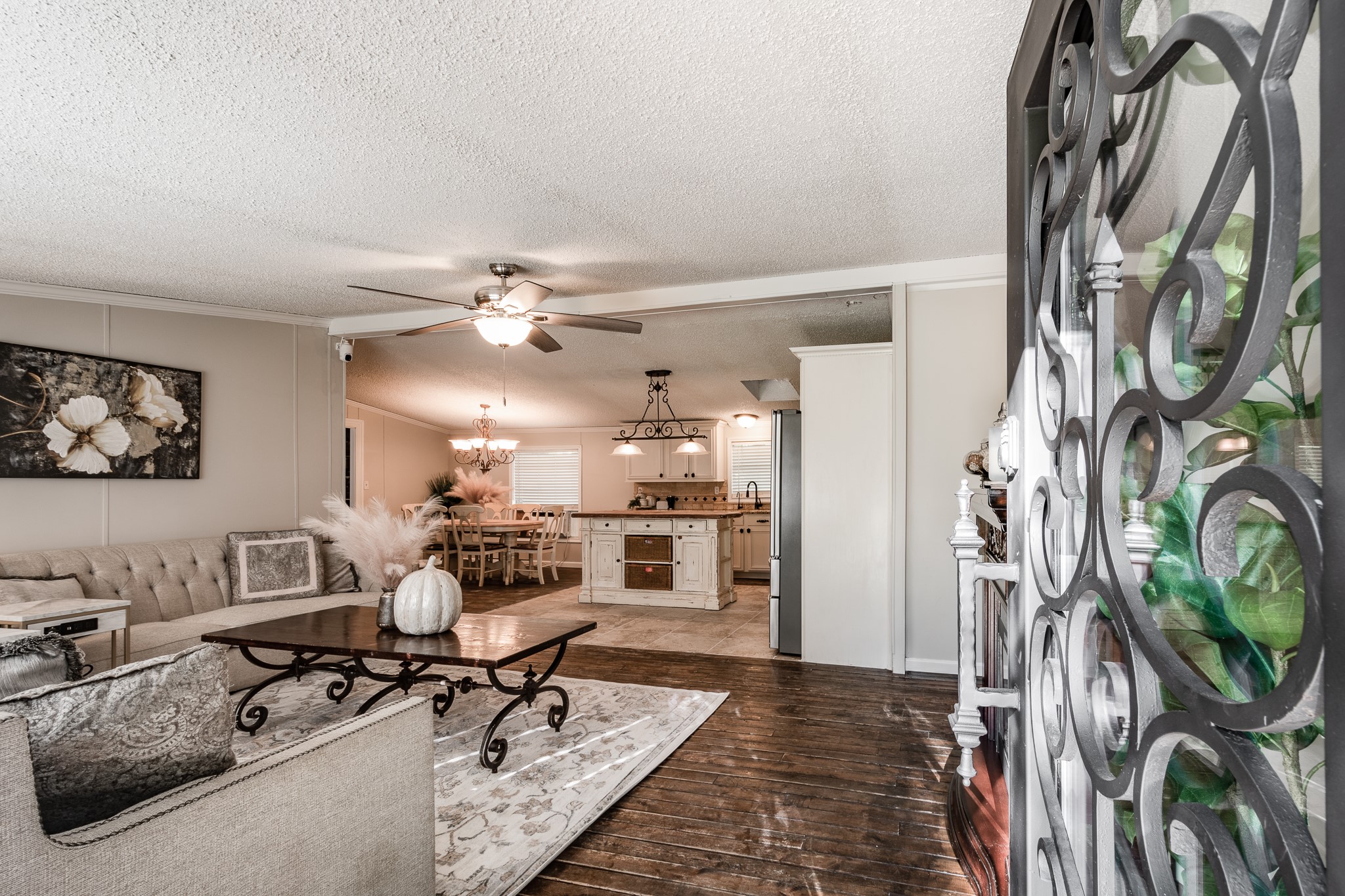 a living room with furniture and a chandelier