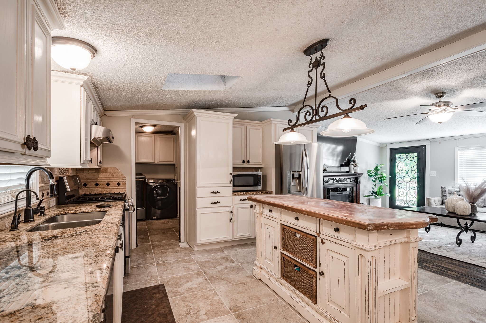 24274 Enloe Road Porter, TX 77365 - Photo 13 of 29 a large kitchen with stainless steel appliances kitchen island granite countertop a sink and cabinets