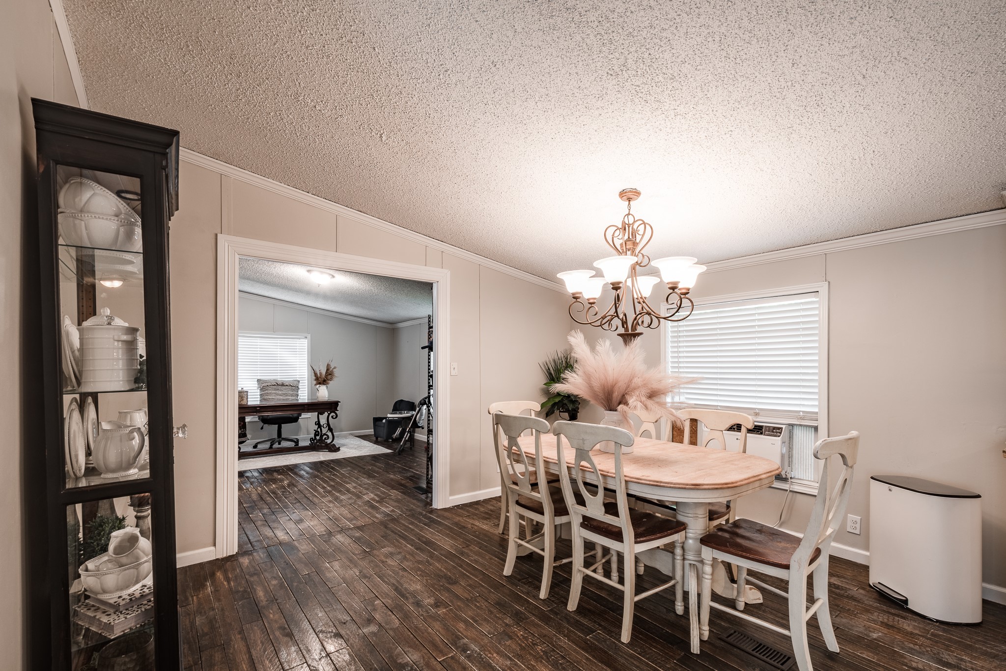 24274 Enloe Road Porter, TX 77365 - Photo 15 of 29 a dining room with wooden floor a chandelier a wooden table and chairs