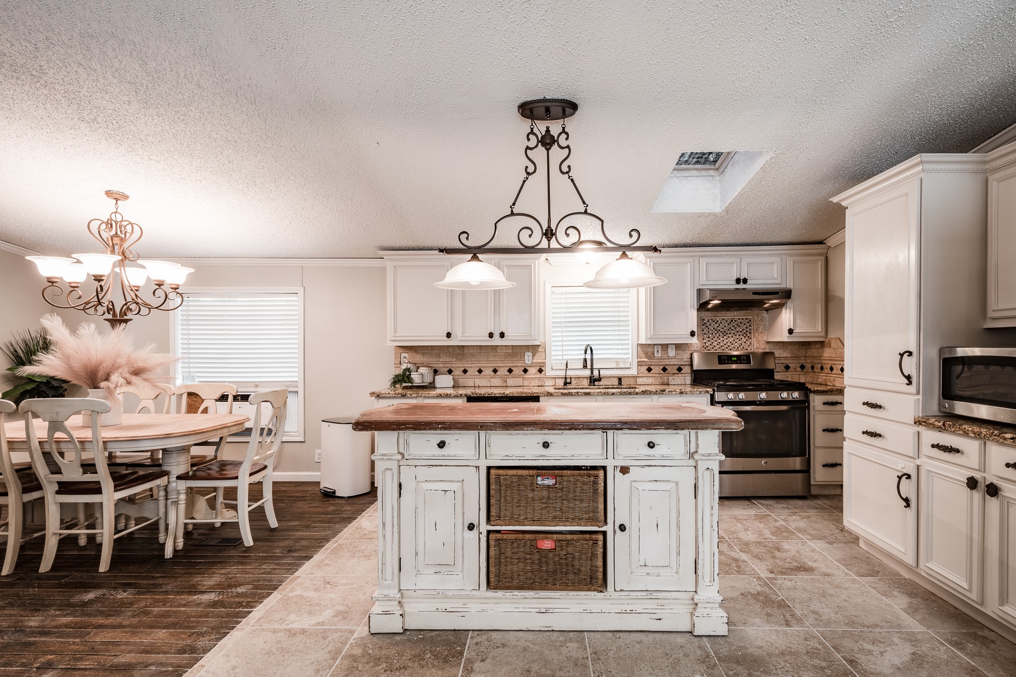 24274 Enloe Road Porter, TX 77365 - Photo 3 of 29 a kitchen with a stove cabinets and stainless steel appliances